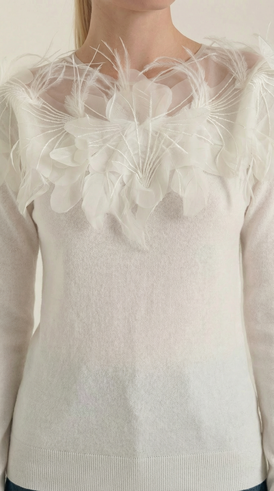 Knitted sweater with feather embellishments